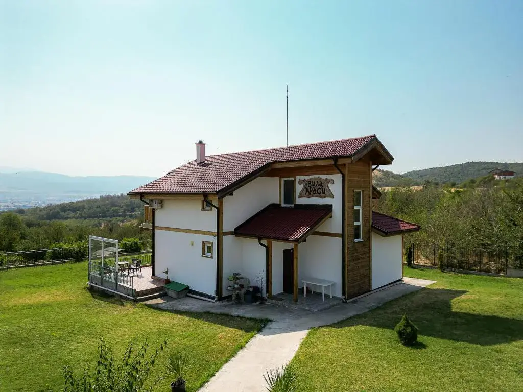 Villa Krasi exterior with mountain backdrop