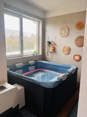 Indoor blue soaking tub with towel caddy and woven wall decor