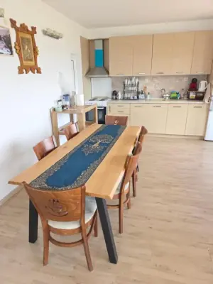 Open-plan kitchen and dining with wooden table and four chairs