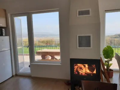 Living room with wood-burning stove and sliding glass doors to balcony
