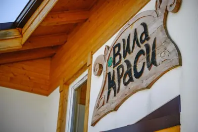 Wooden carved sign 'Vila Krasi' on villa facade
