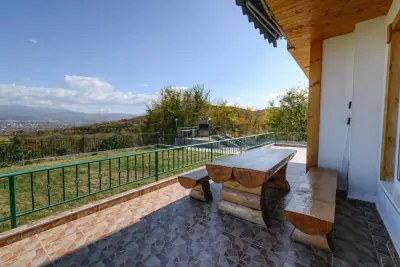Terrace with rustic log table and mountain view