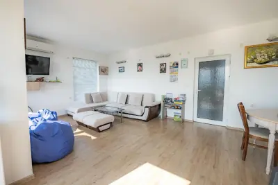 Living room with corner sofa, blue bean bags and dining area