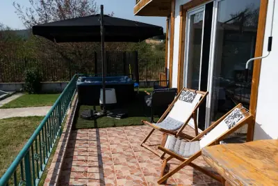 Terrace with deck chairs, jacuzzi and sliding glass doors