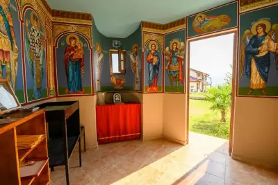 Chapel interior with icons, wooden desk and open door